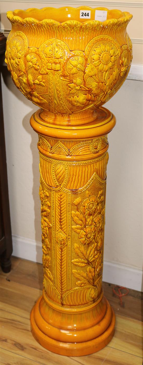 A Burmantofts faience amber glazed pottery jardiniere and pedestal, overall height 105cm